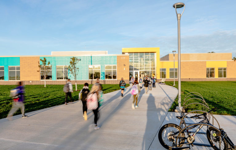 Exterior lit by sun with children walking to school