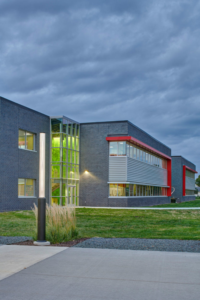 Exterior dusk with green wall graphic