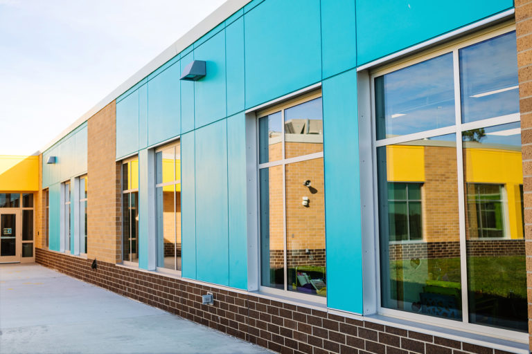 Exterior blue panels with reflections in glass