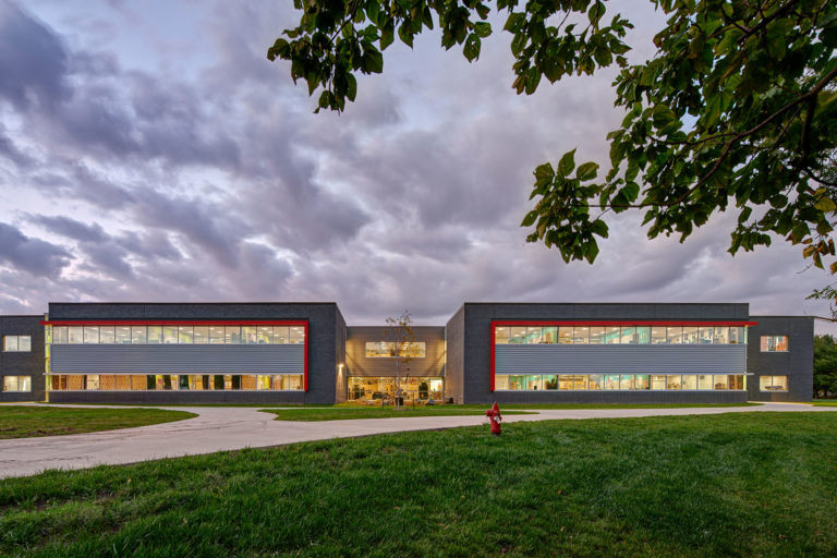 Exterior at dusk showing classroom wings