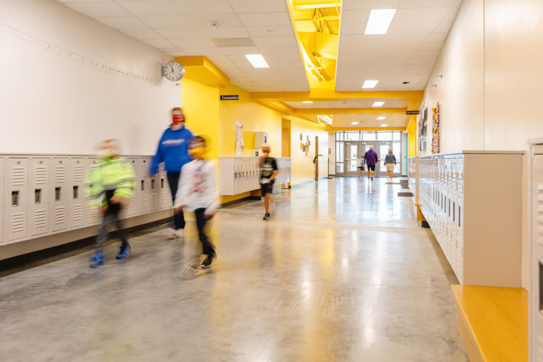 Corridor with yellow accents and students