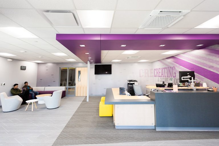 Reception desk with purple ceiling elements