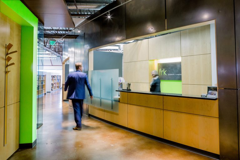 Reception desk with green feature wall