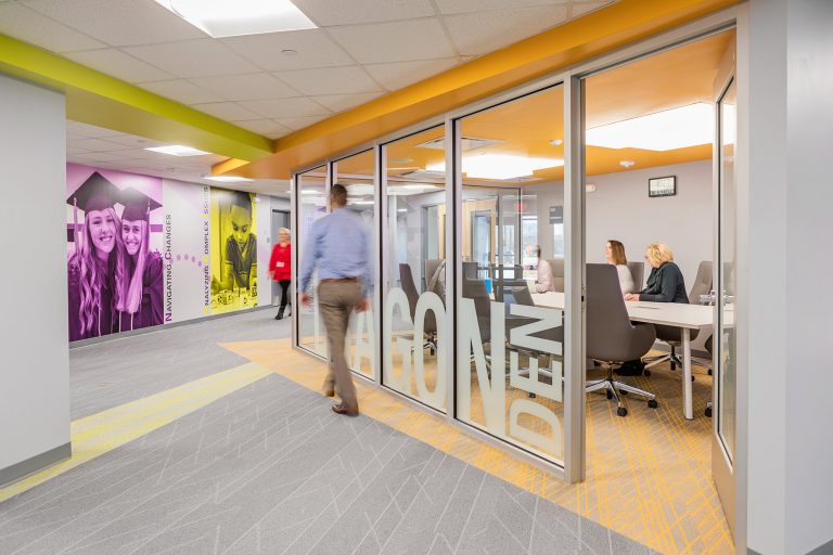 Looking into conference room with orange ceiling and carpet details