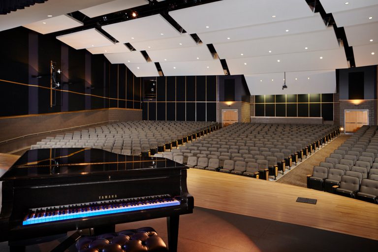 Auditorium highlighting piano and ceiling sound elements