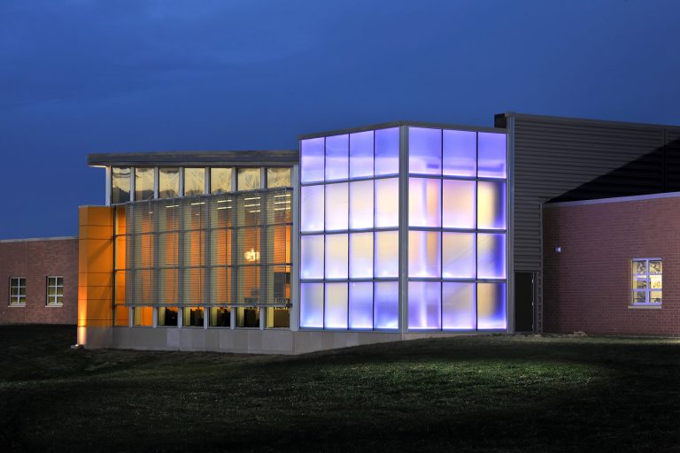 Night exterior with purple lit windows