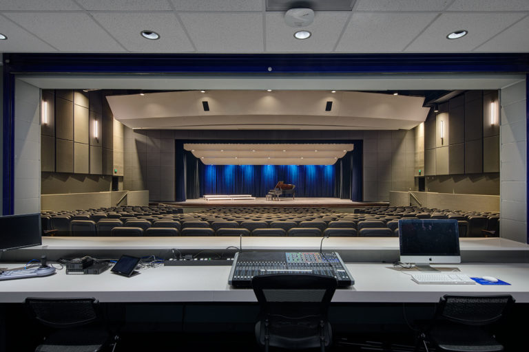 Looking at stage from sound booth. Equipment in the foreground.