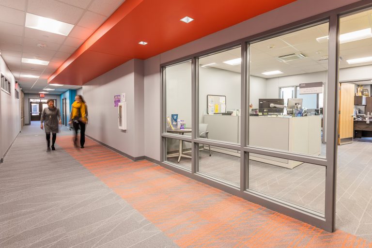 Hall with workers looking into office