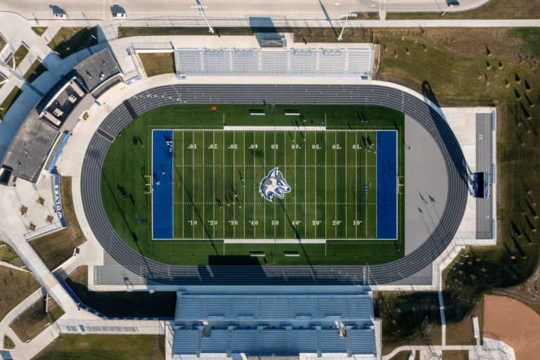 Overhead view of football stadium featuring wolf logo