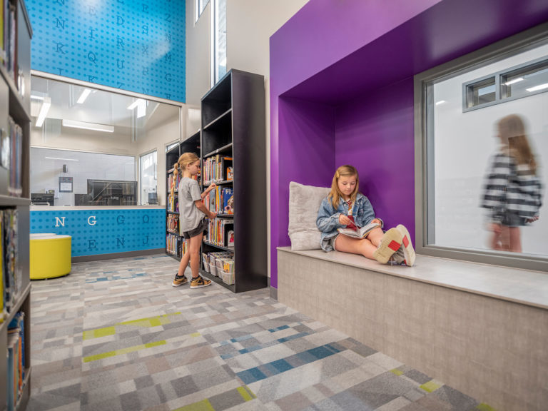 Inside the library looking out at hallway through projected alcove space