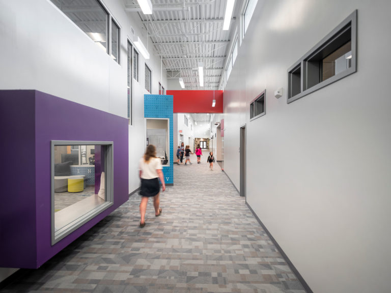 Main corridor with exposed ceilings showing library alcove