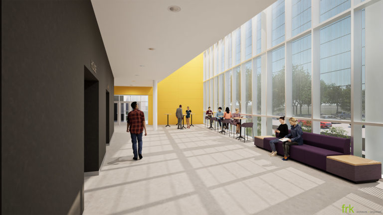 Auditorium lobby featuring yellow wall panels